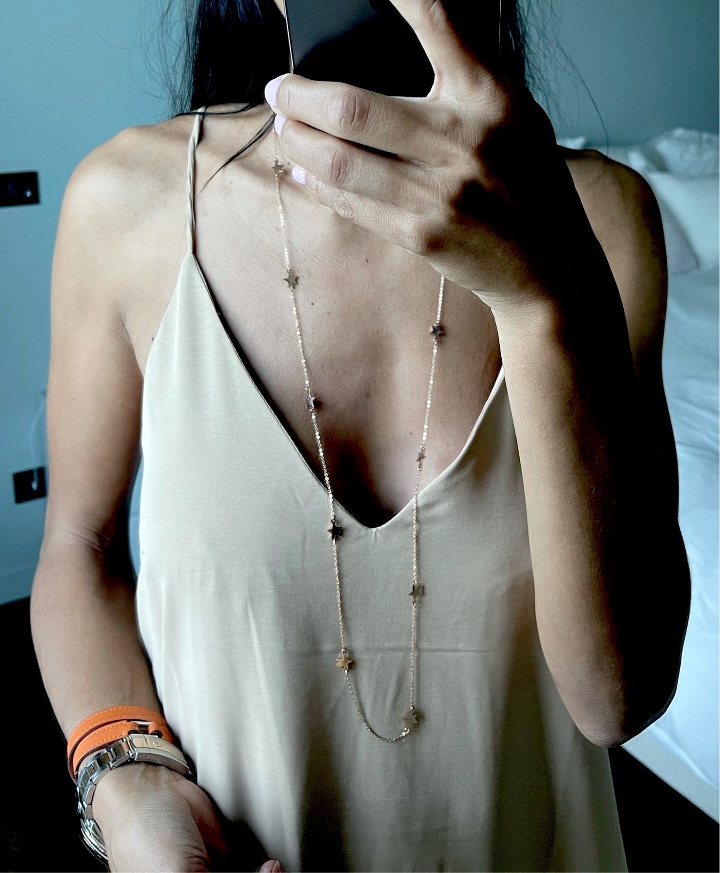 Détail de la robe beige à fines bretelles, simplicité élégante.