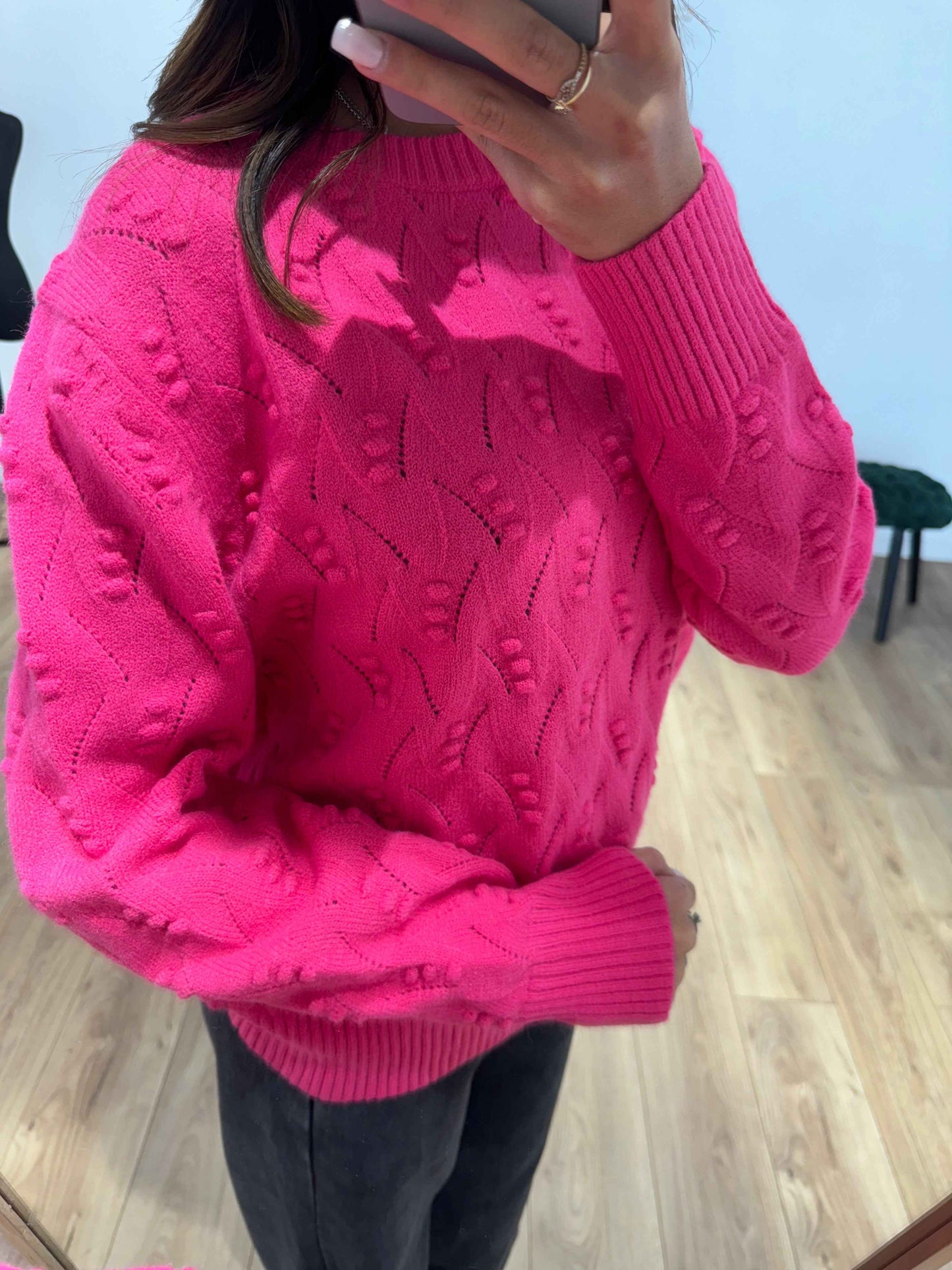 Gros plan sur les manches d'un pull cachemire rose fuchsia