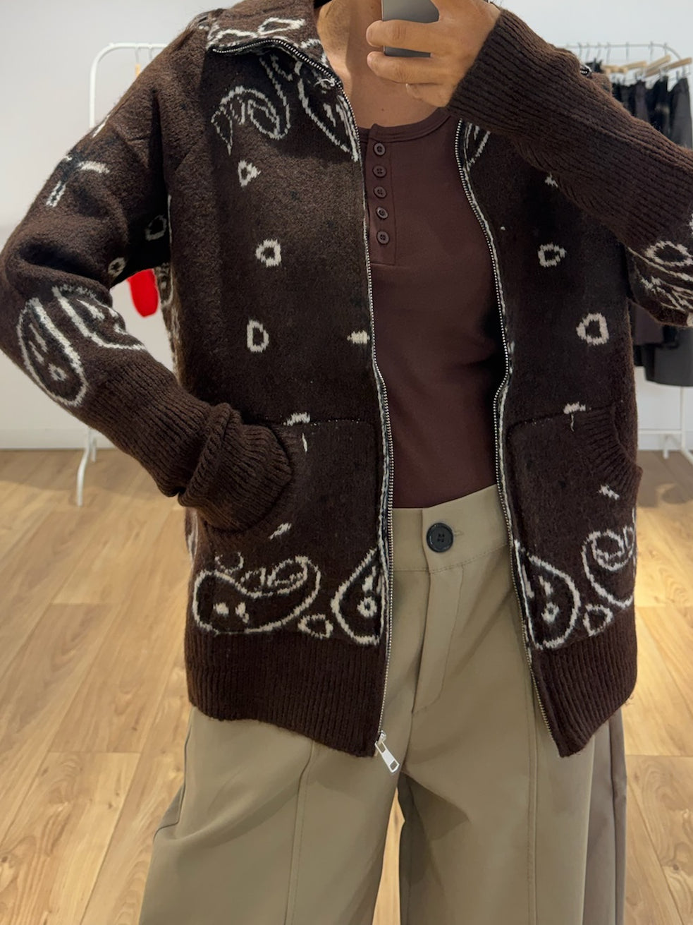 Gilet jacquard marron porté ouvert sur pantalon beige
