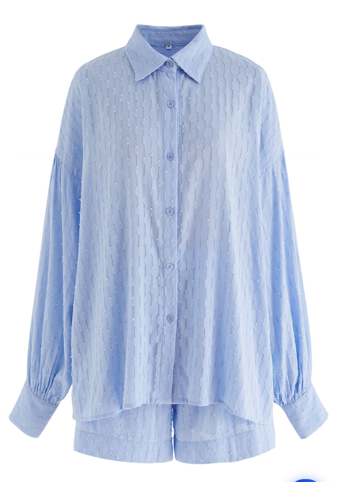 Vue arrière de l'ensemble chemise et short bleu clair pour femme, tissu texturé.