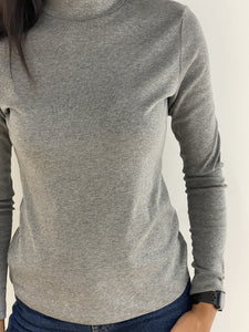 Femme portant un pull gris en tricot fin à col rond