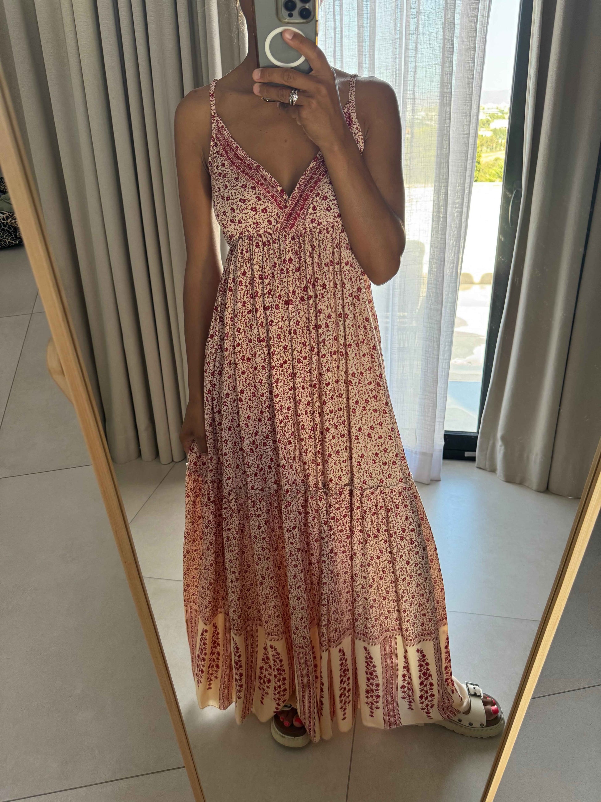 Femme portant une robe longue à fines bretelles imprimée rouge, vue de face