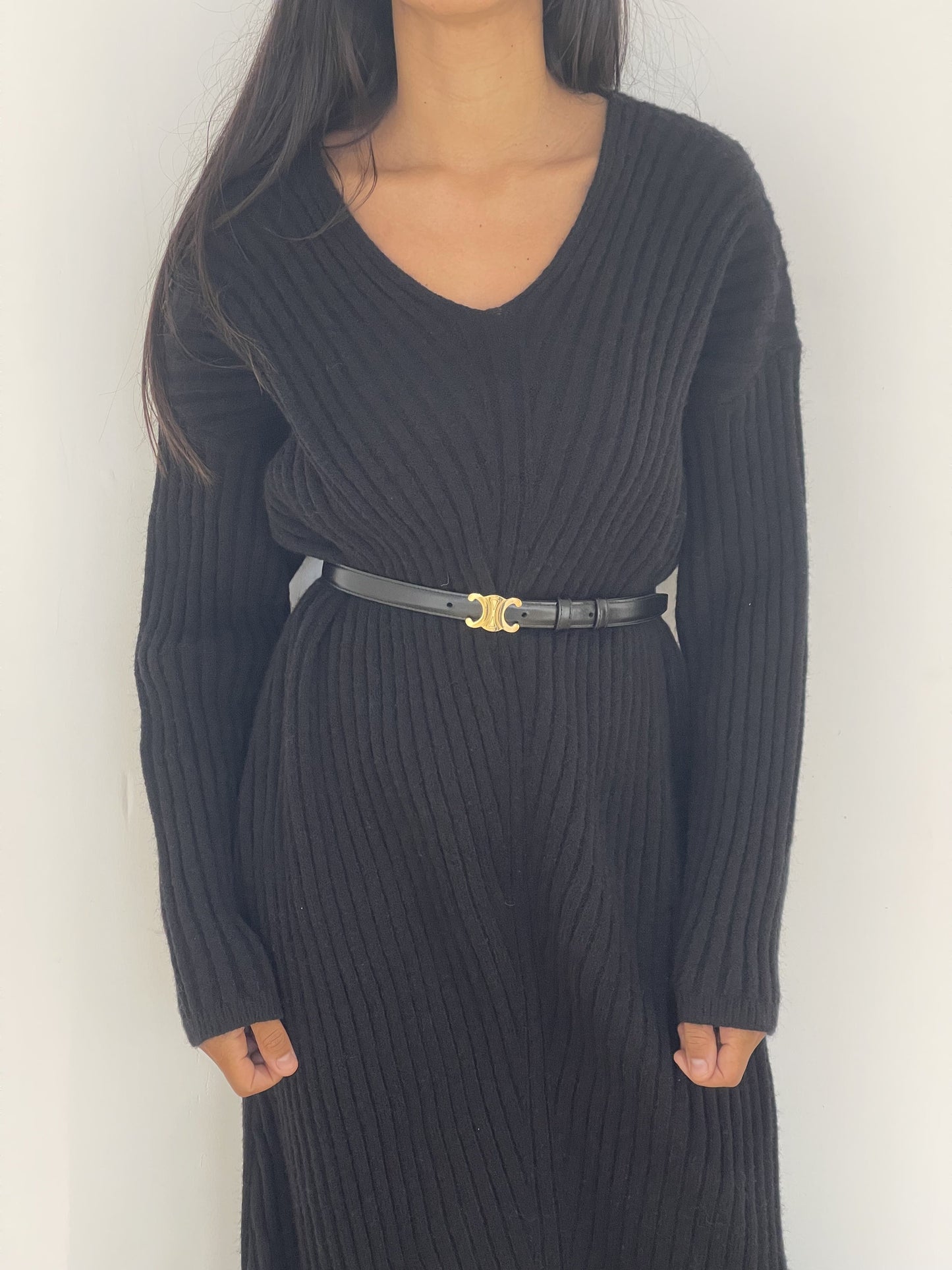 Robe en maille noire avec ceinture dorée pour une touche moderne